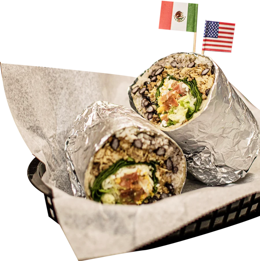 Burritos wrapped in foil in a basket with Mexican and American flags