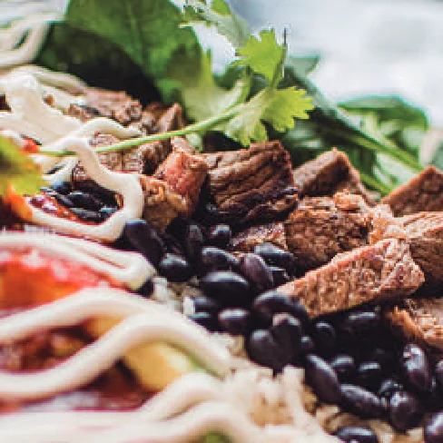 Grilled steak with black beans, rice and sour cream